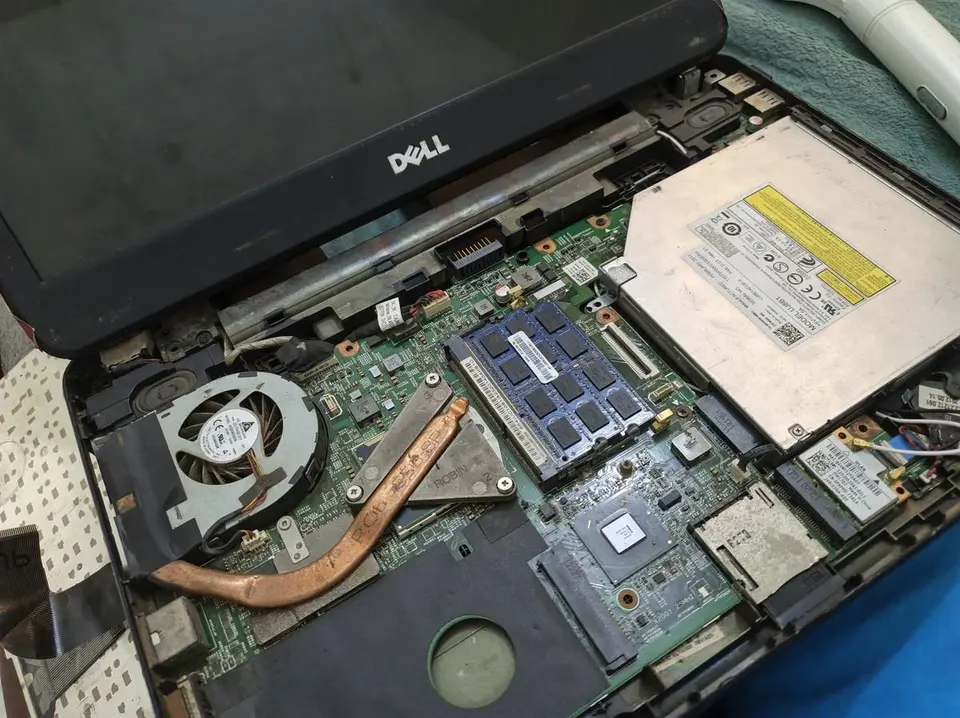 Laptop opened up showing fan, heatsink and memory