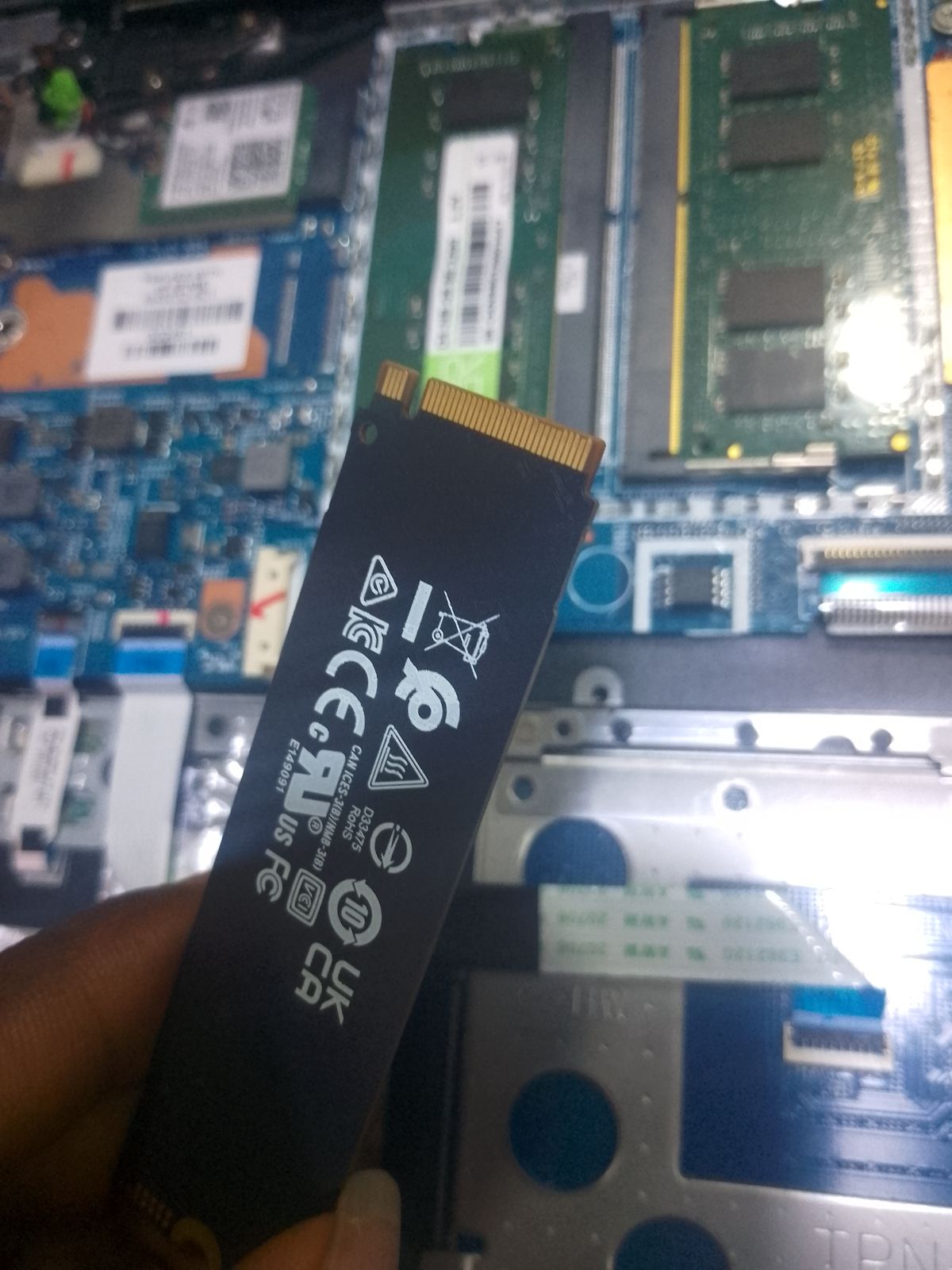 M.2 NVMe SSD over an open laptop